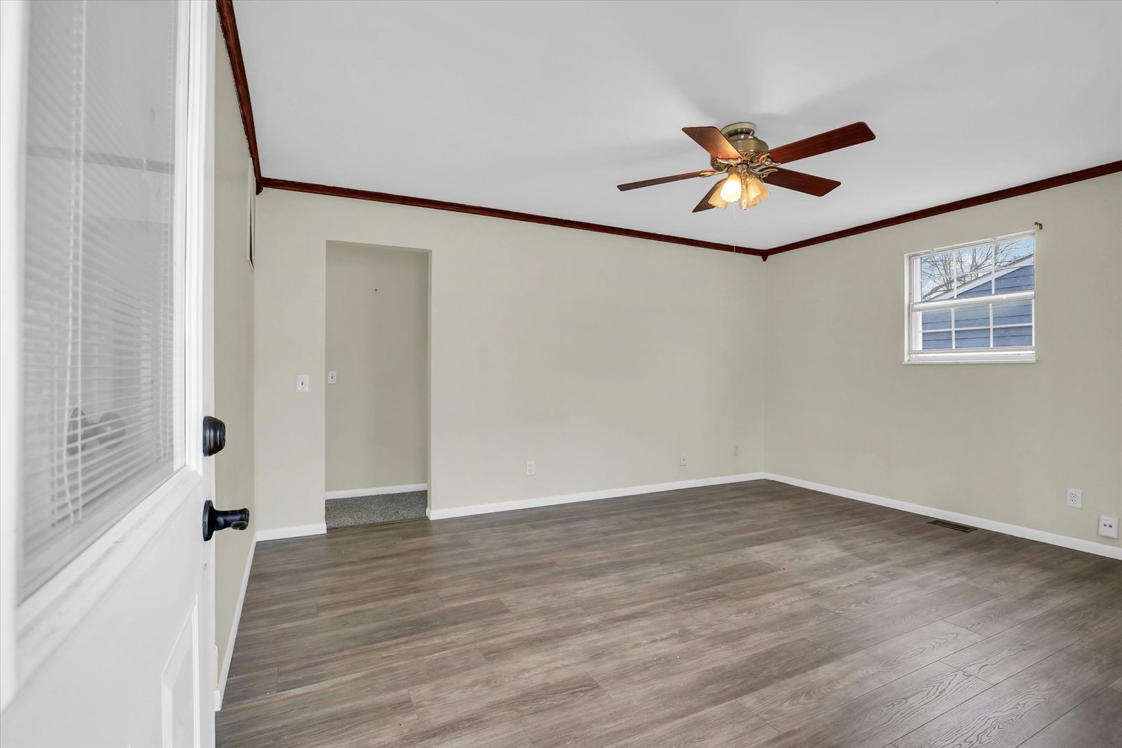 3206 York Drive Champaign, IL 61821 - Photo 12 of 24 a view of an empty room with wooden floor and a window