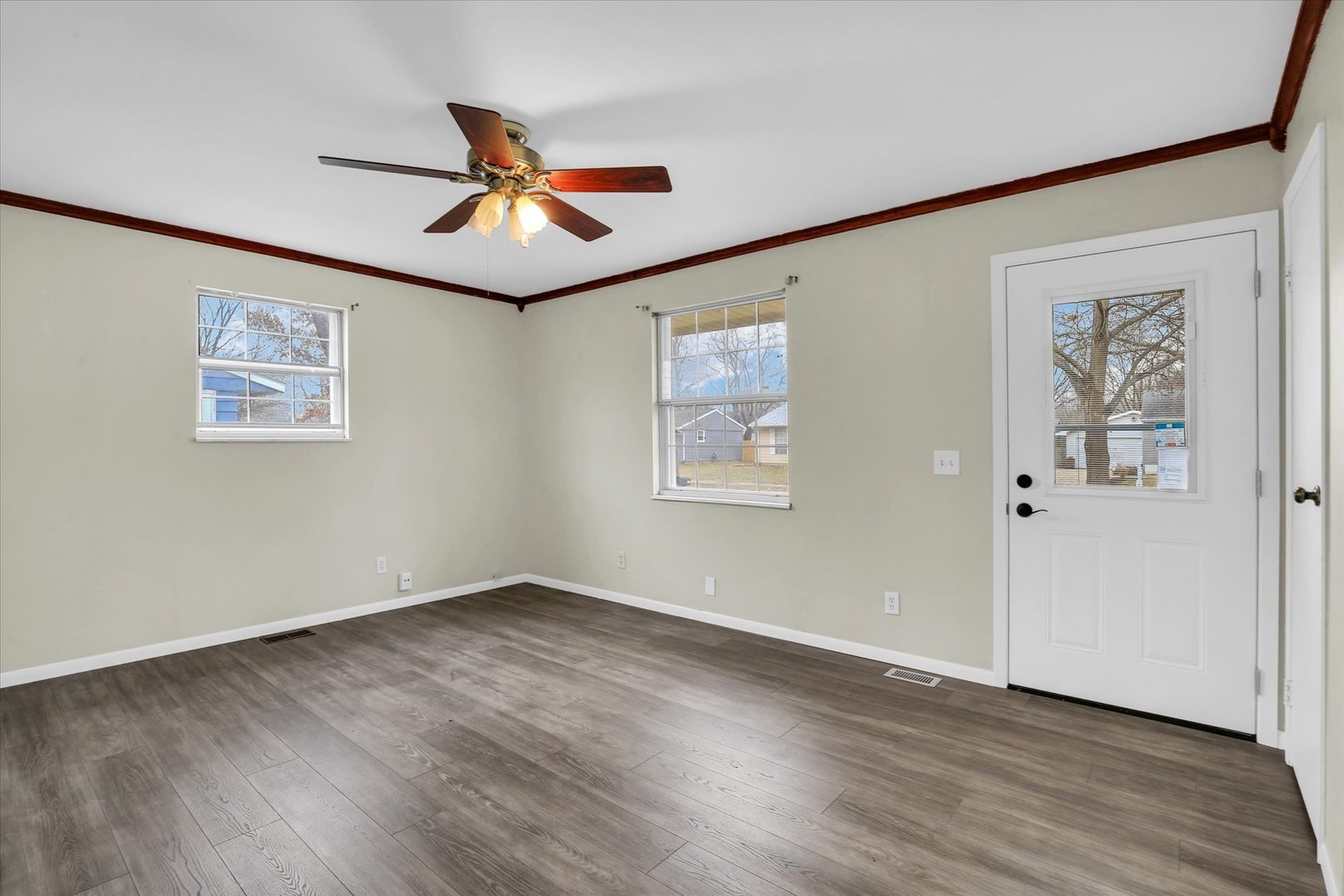 3206 York Drive Champaign, IL 61821 - Photo 13 of 24 a view of an empty room with wooden floor and a ceiling fan