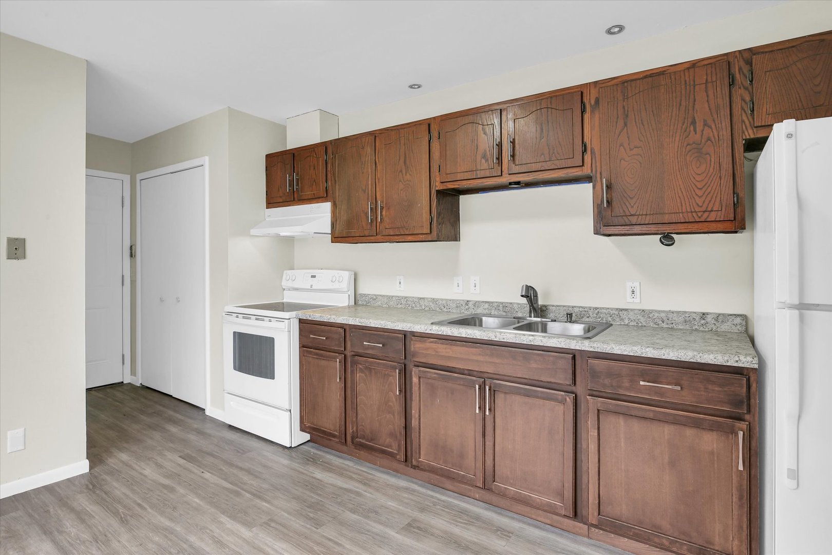 3206 York Drive Champaign, IL 61821 - Photo 14 of 24 a kitchen with granite countertop cabinets stainless steel appliances a sink and wooden floor