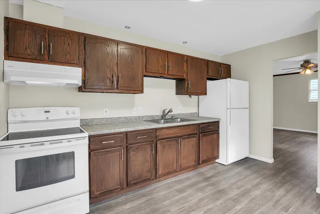 a kitchen with a sink stove and refrigerator
