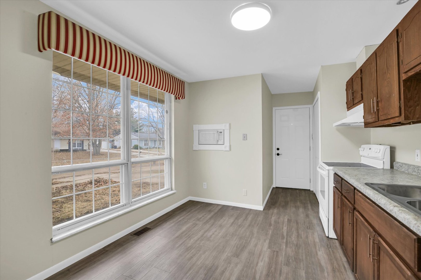 3206 York Drive Champaign, IL 61821 - Photo 16 of 24 a kitchen with wooden floor and a sink