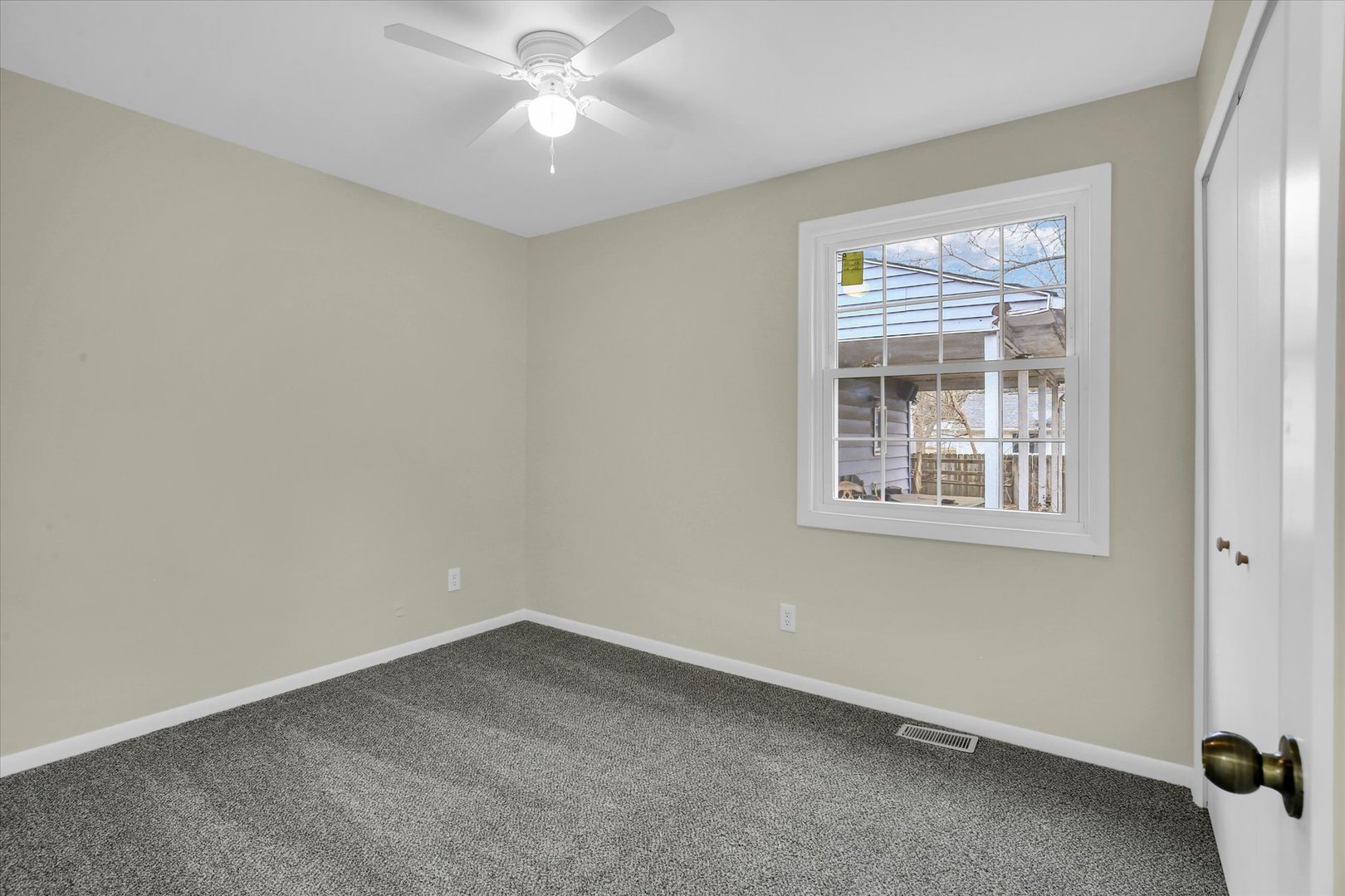 3206 York Drive Champaign, IL 61821 - Photo 20 of 24 an empty room with a window and a fan