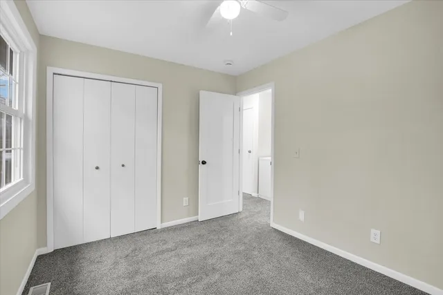 a view of an empty room and a window