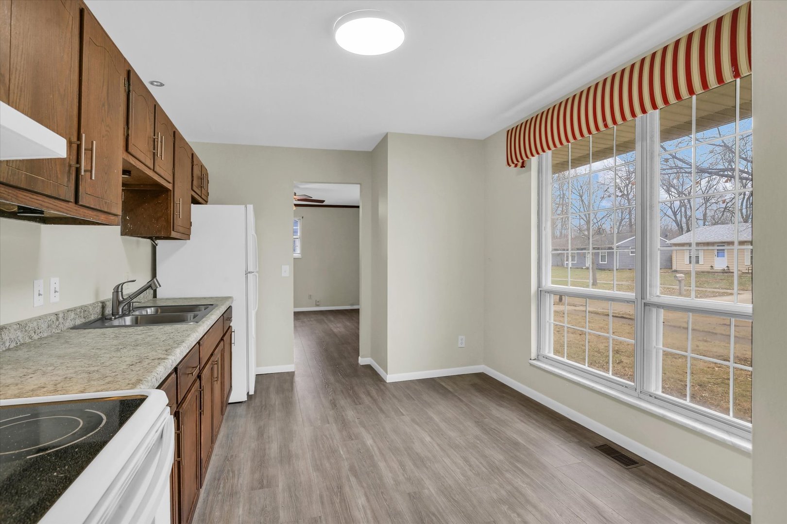 3206 York Drive Champaign, IL 61821 - Photo 3 of 24 a kitchen with kitchen island granite countertop a sink and a stove