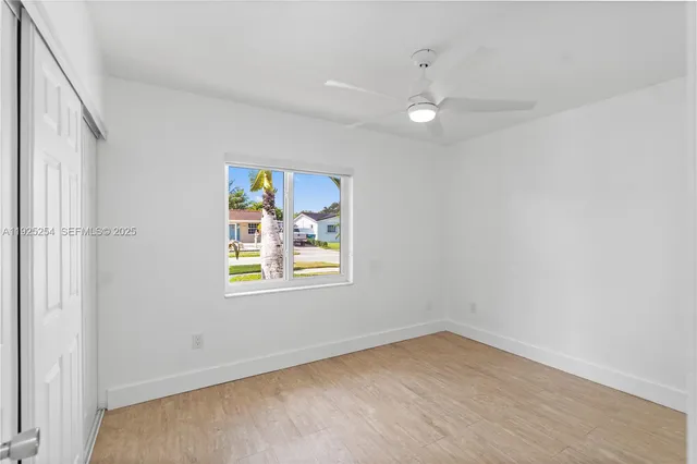 wooden floor in an empty room with a window