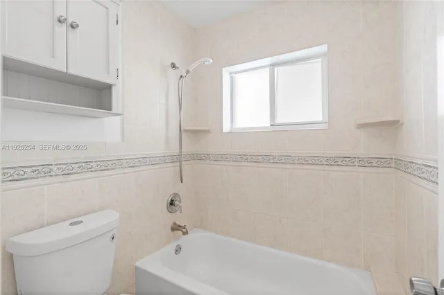 a bathroom with a bathtub and a window