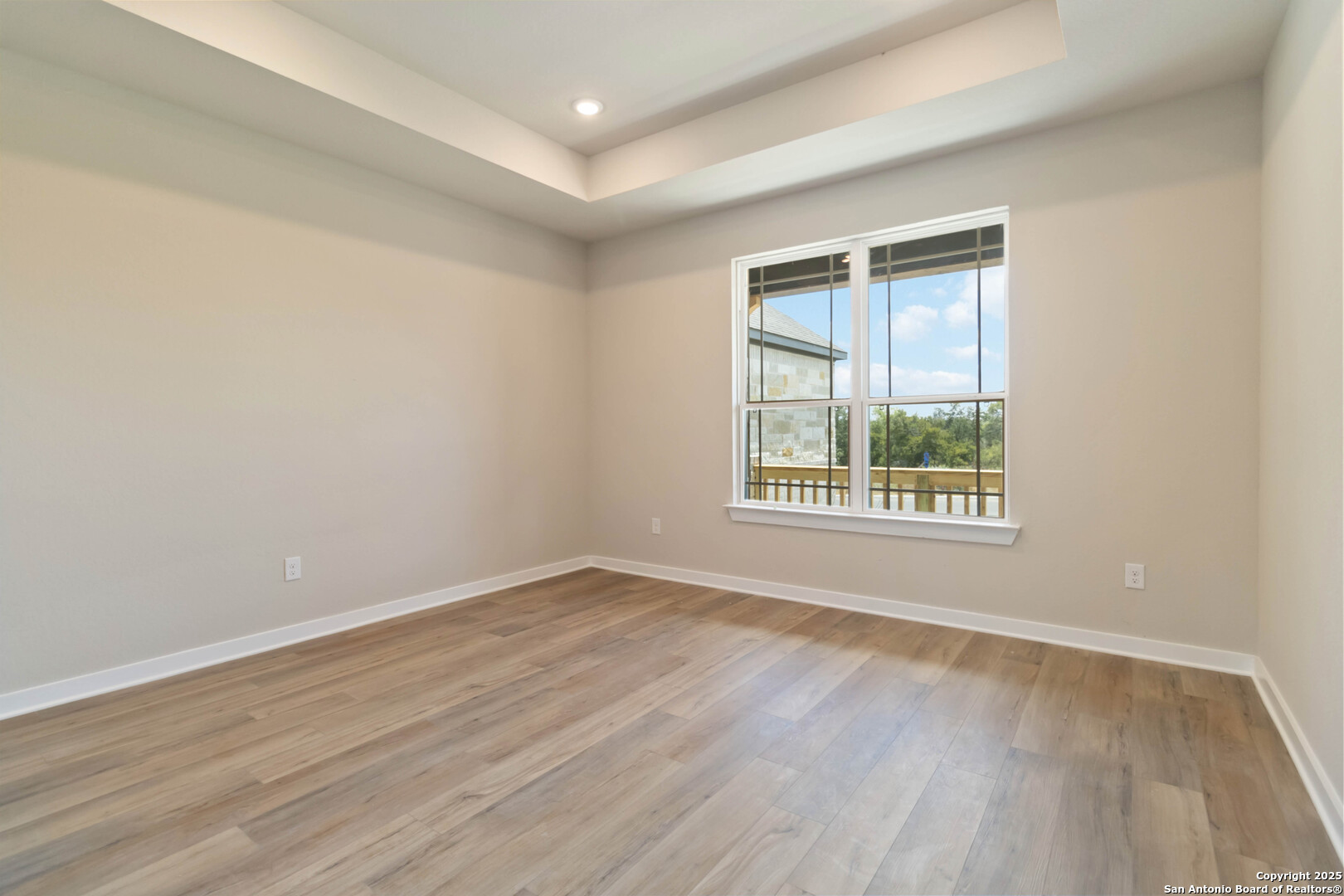 21225 Jordans Ranch Way San Antonio, TX 78264 - Photo 16 of 30 a view of an empty room with wooden floor and a window