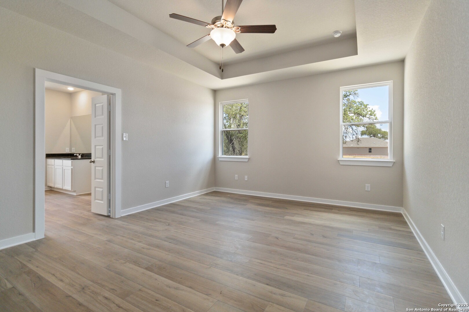 21225 Jordans Ranch Way San Antonio, TX 78264 - Photo 18 of 30 wooden floor in an empty room with a window