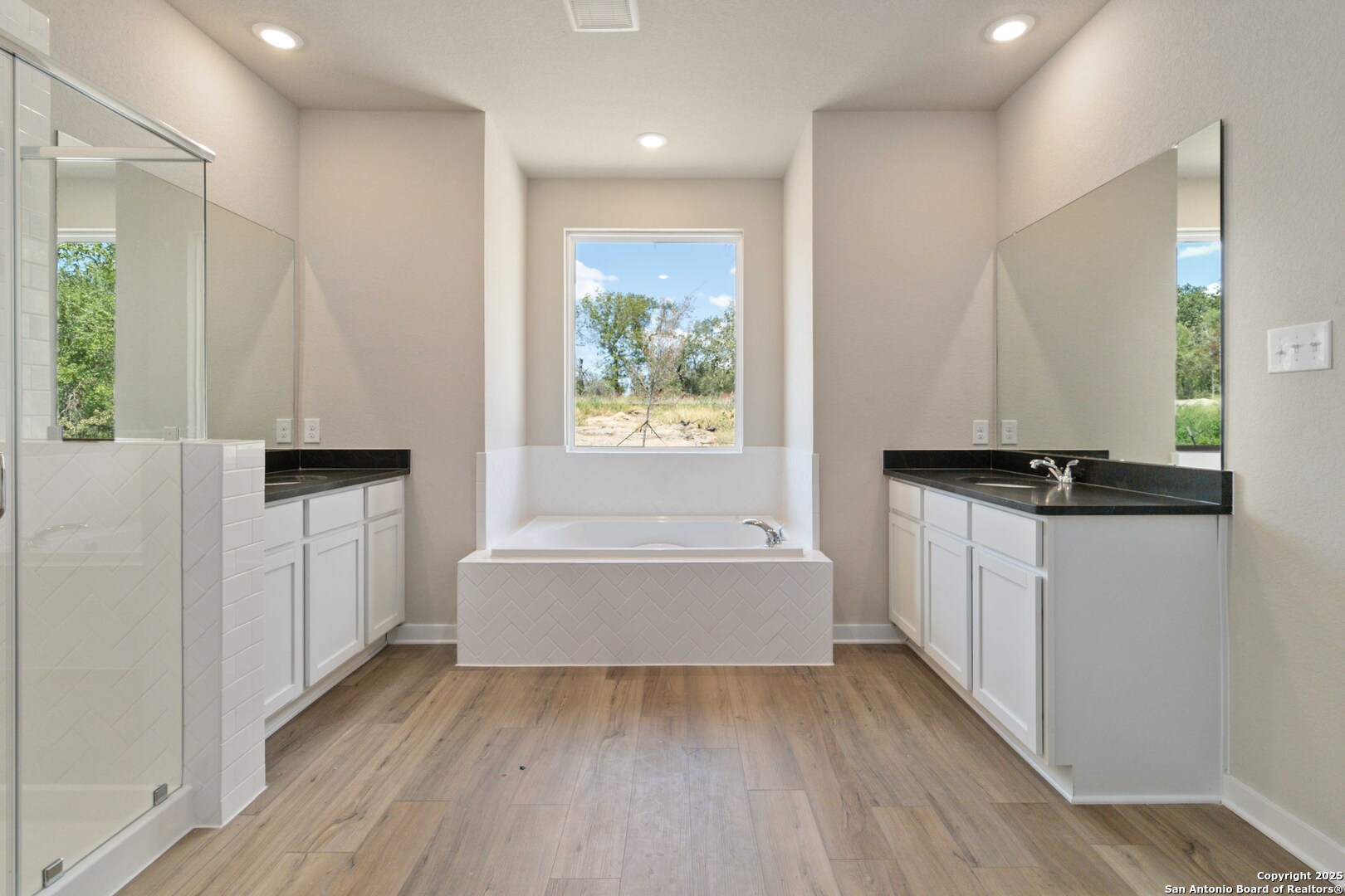 21225 Jordans Ranch Way San Antonio, TX 78264 - Photo 20 of 30 a bathroom with a bathtub and a window