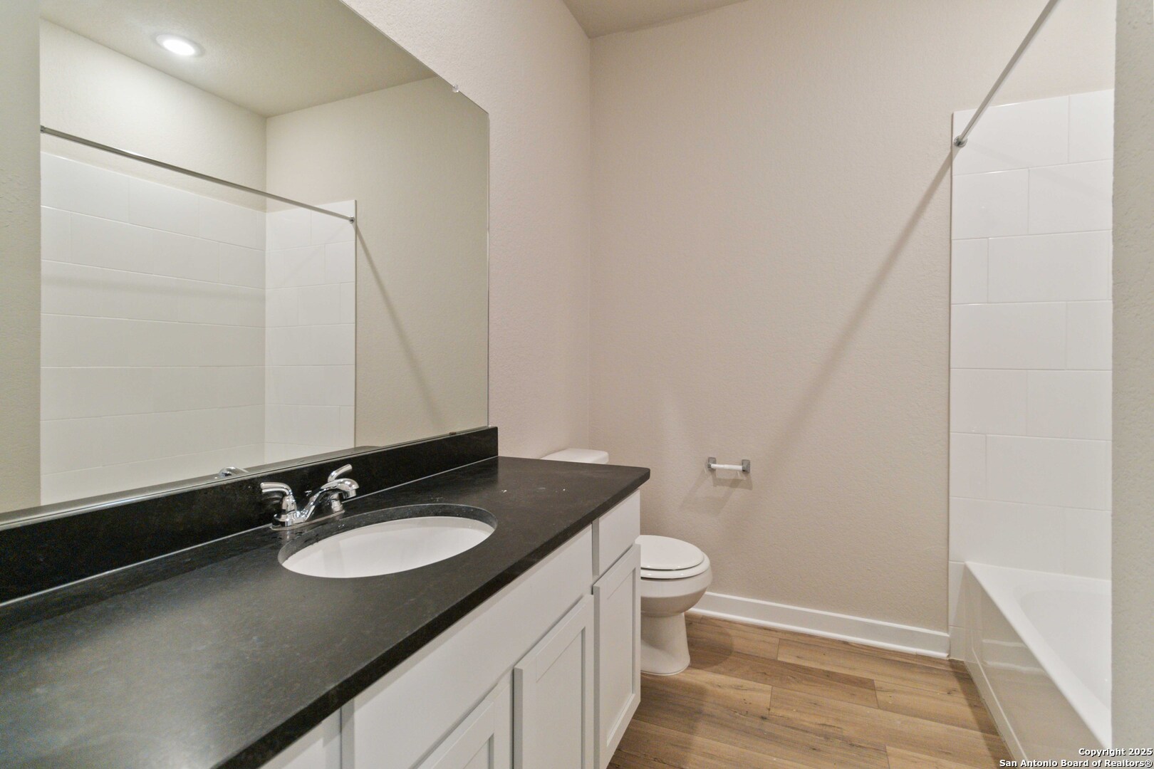 21225 Jordans Ranch Way San Antonio, TX 78264 - Photo 26 of 30 a bathroom with a granite countertop sink toilet and shower