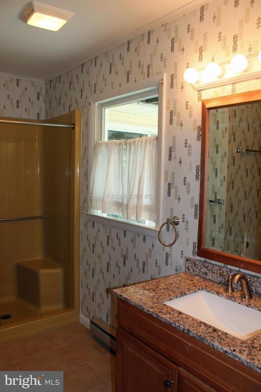 20 Brookside Road Ocean Pines, MD 21811 - Photo 13 of 20 a bathroom with a granite countertop sink and a mirror