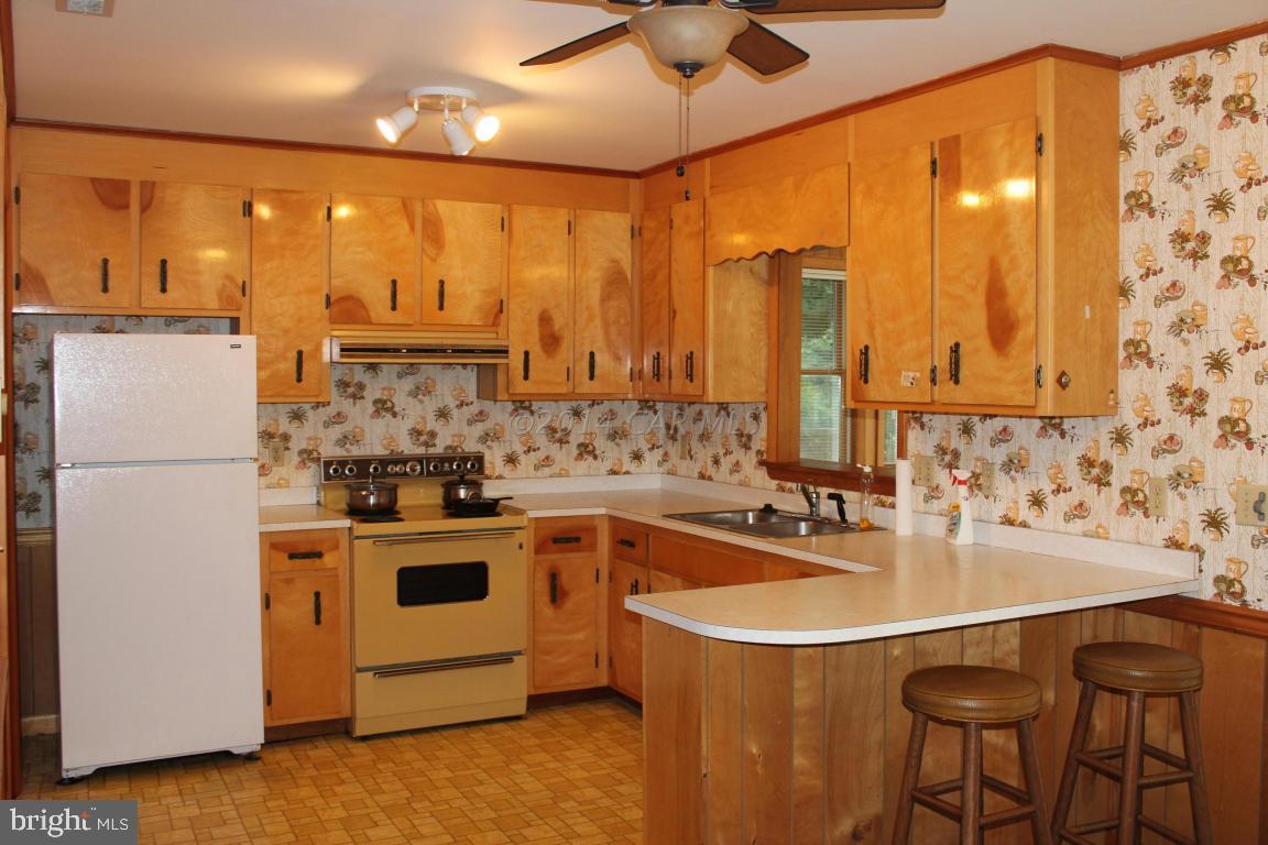 20 Brookside Road Ocean Pines, MD 21811 - Photo 6 of 20 a kitchen with stainless steel appliances a sink a stove and a refrigerator