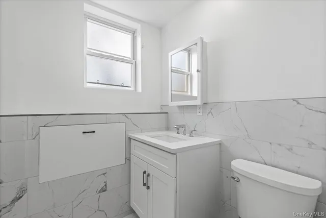 a bathroom with a sink toilet and vanity