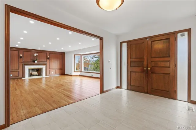 a view of empty room with wooden floor and windows