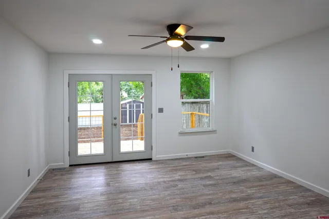 wooden floor in an empty room with a window