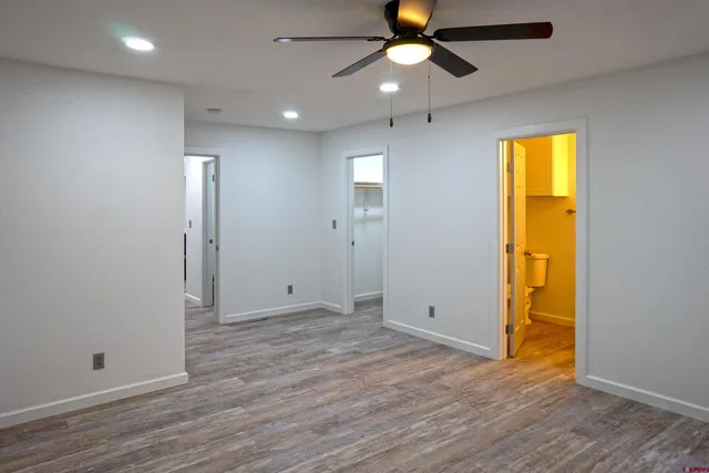 an empty room with wooden floor and door