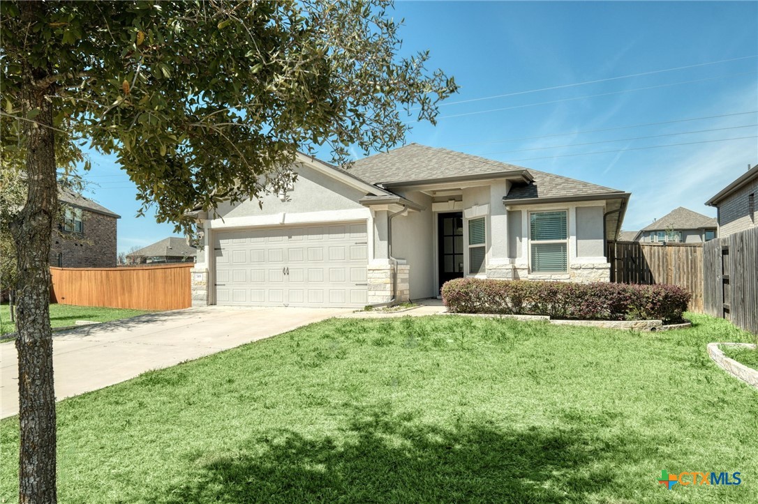a front view of a house with a yard and garage