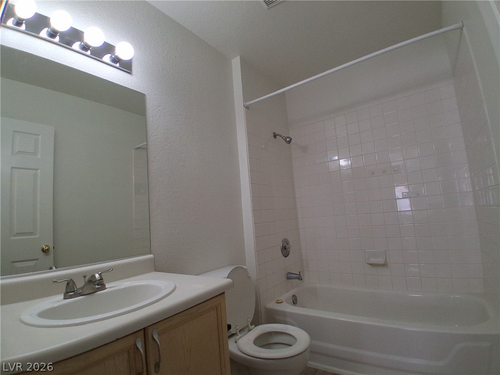 8023 Simone Avenue Las Vegas, NV 89147 - Photo 9 of 12 A well-appointed bathroom offers a clean vanity, shower, and commode for daily routines.