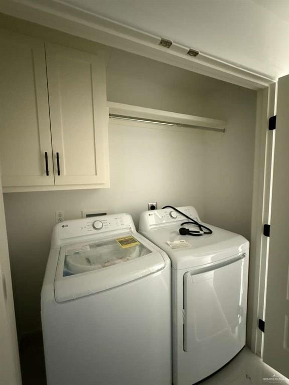 1825 Sunset Drive Mission, TX 78572 - Photo 11 of 12 Laundry area featuring washing machine and clothes dryer and cabinet space