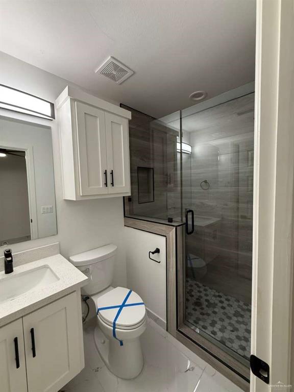 1825 Sunset Drive Mission, TX 78572 - Photo 8 of 12 Bathroom featuring a stall shower and vanity