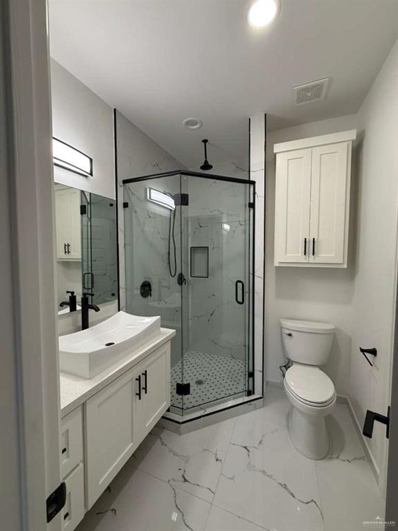 1825 Sunset Drive Mission, TX 78572 - Photo 9 of 12 Full bath featuring vanity, light marble finish flooring, and a marble finish shower