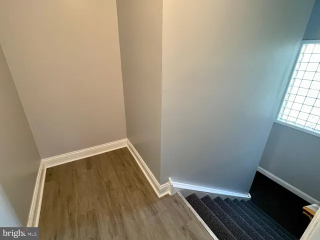 an empty room with window and a bathroom