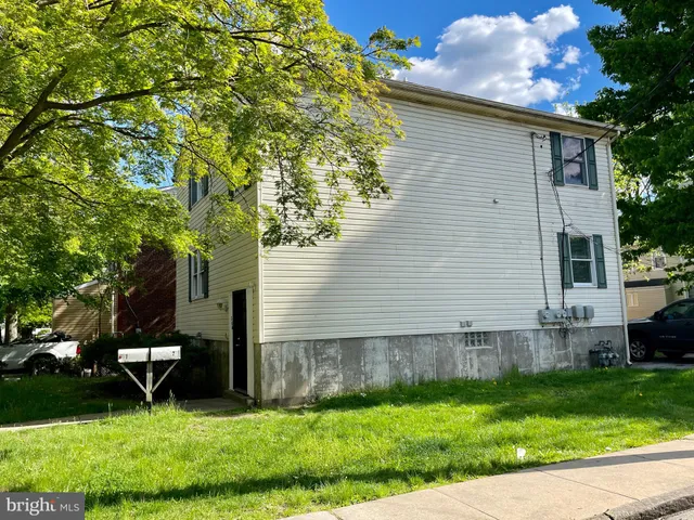 a backyard of a house with garden and trees