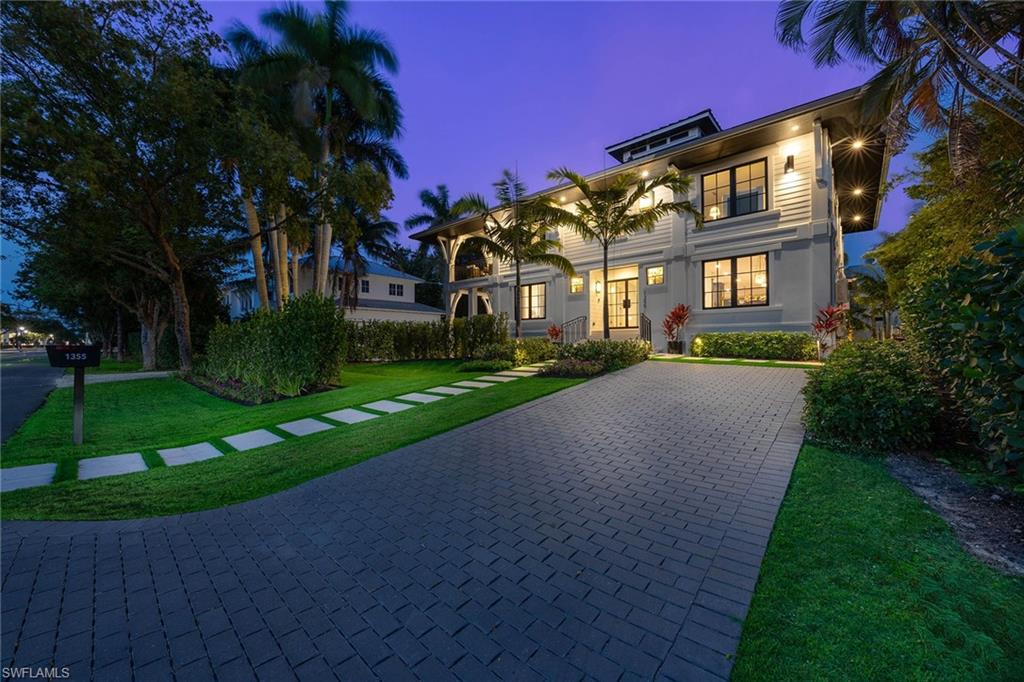 1355 4th Street South Naples, FL 34102 - Photo 11 of 50 a front view of a house with a yard and garage