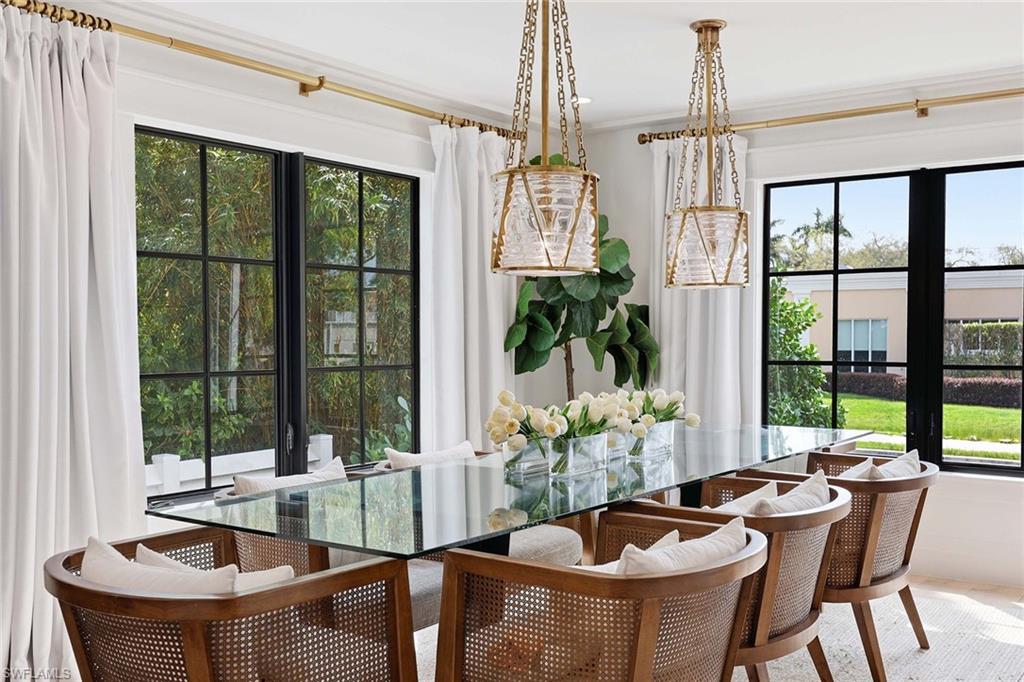 1355 4th Street South Naples, FL 34102 - Photo 13 of 50 a dining room with furniture a chandelier and wooden floor