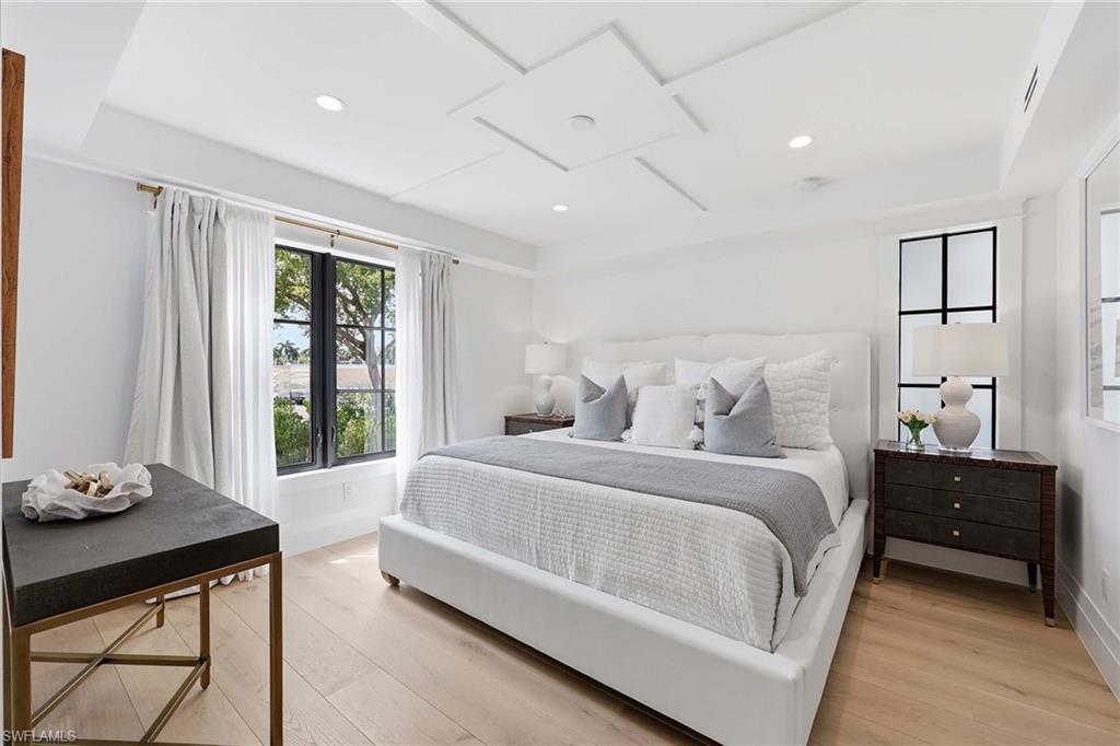 1355 4th Street South Naples, FL 34102 - Photo 15 of 50 a bedroom with a bed and a table