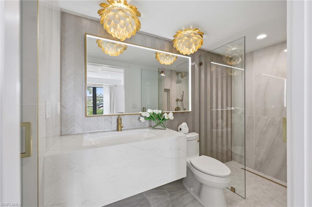 1355 4th Street South Naples, FL 34102 - Photo 16 of 50 a bathroom with a sink a toilet and shower