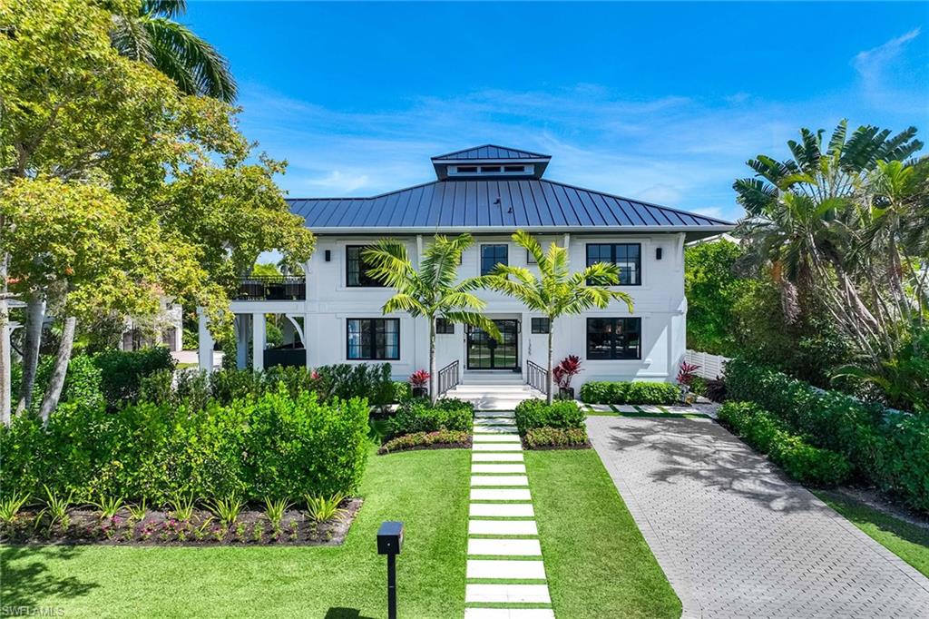 1355 4th Street South Naples, FL 34102 - Photo 2 of 50 a front view of a house with a yard