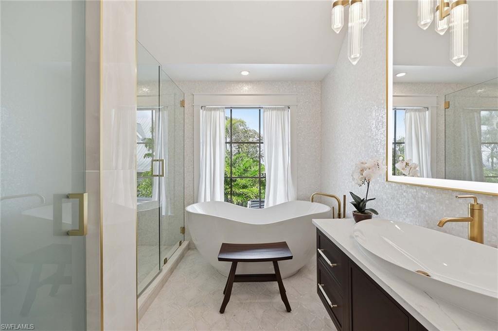 1355 4th Street South Naples, FL 34102 - Photo 32 of 50 a bathroom with a sink a chair and a window