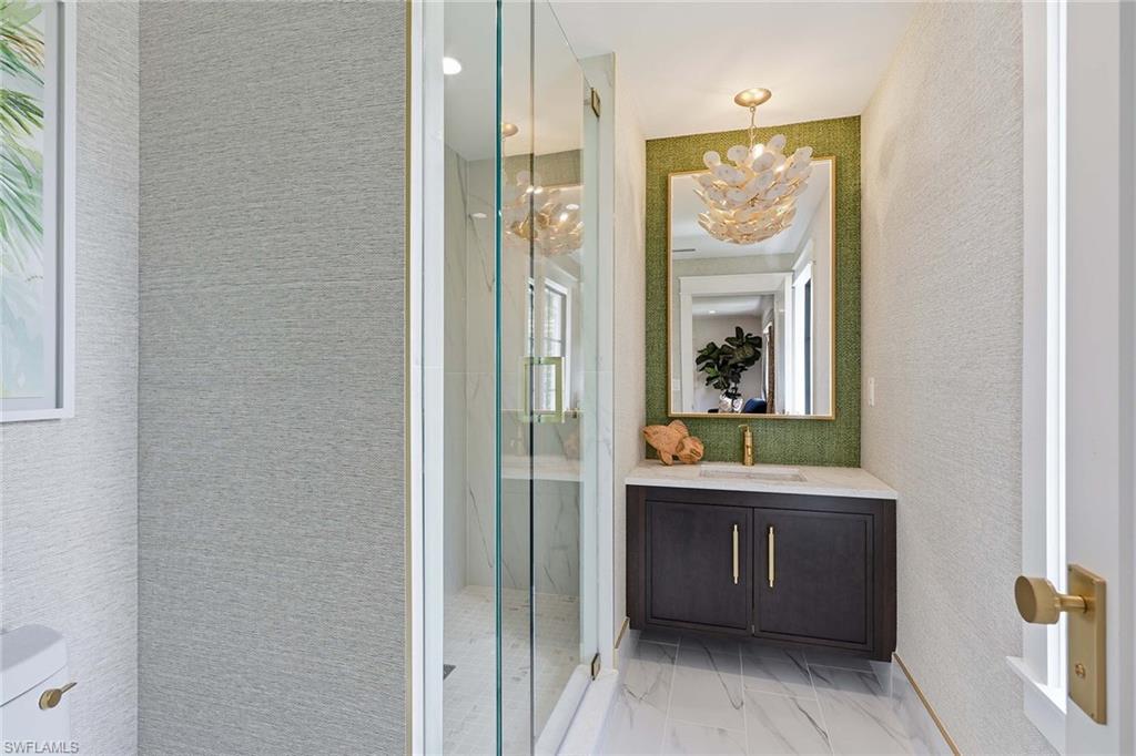 1355 4th Street South Naples, FL 34102 - Photo 39 of 50 a bathroom with a bathtub a mirror and a shower