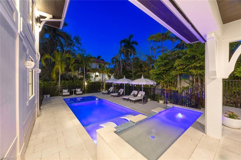 1355 4th Street South Naples, FL 34102 - Photo 4 of 50 a view of swimming pool with lawn chairs and a yard