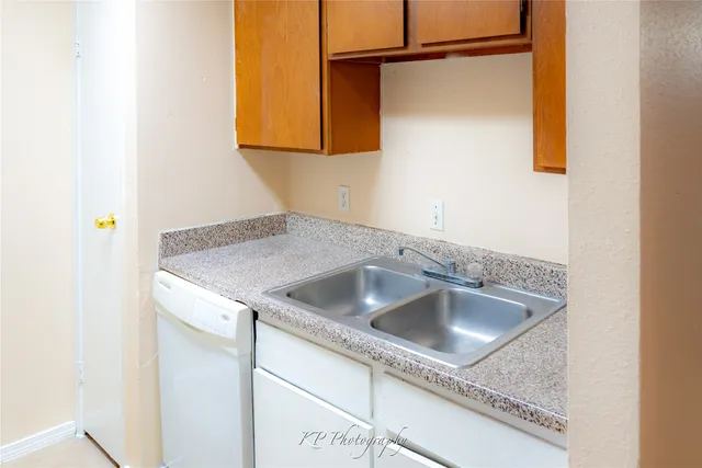 a close view of a sink a refrigerator and a window