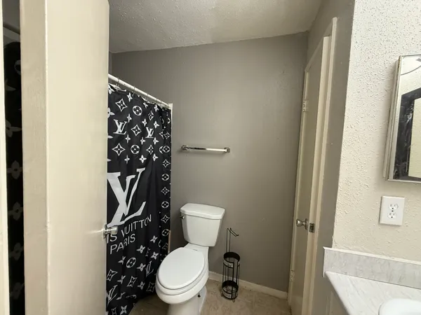 a white toilet sitting next to a small yard