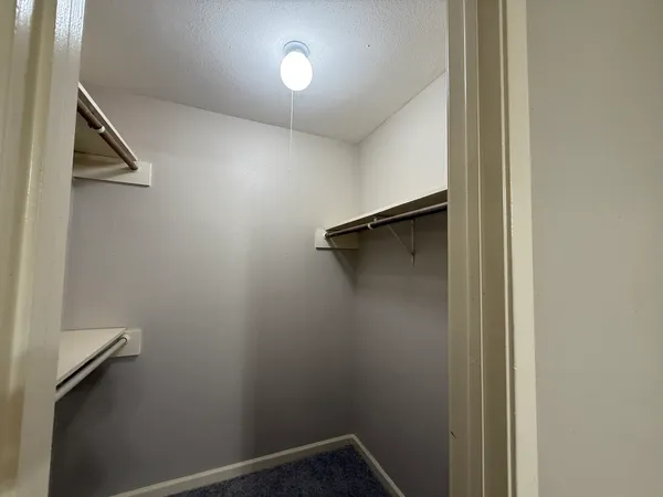 a view of a hallway with wooden shelves