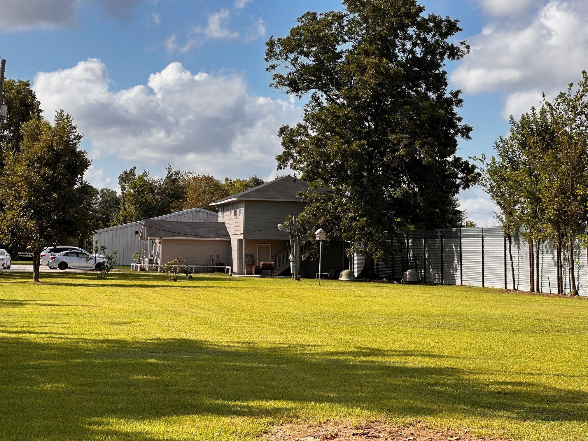 404 Gulf Bank Road Houston, TX 77037 - Photo 3 of 23 a view of a swimming pool with lawn chairs and large trees