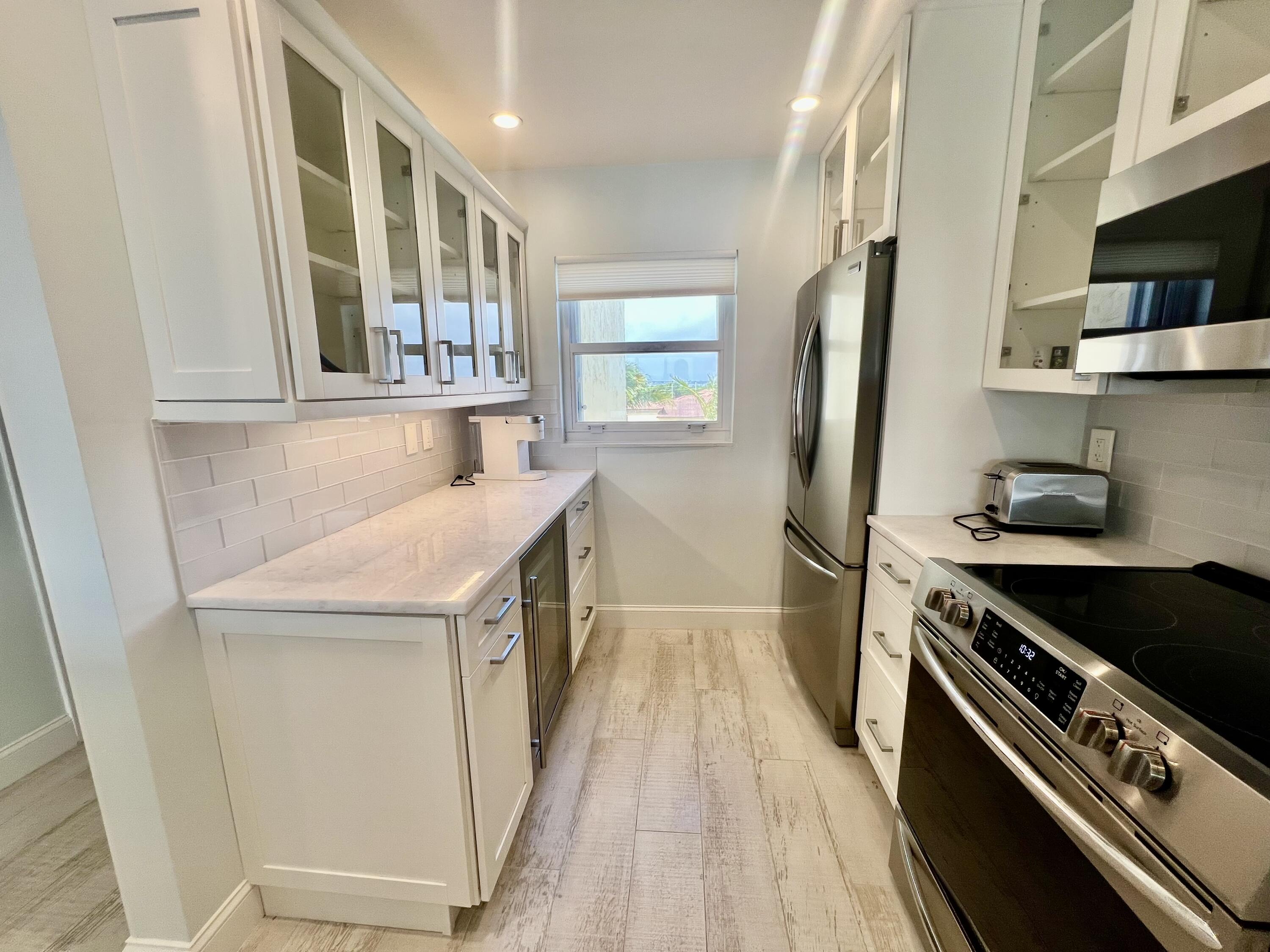 7410 South Ocean Drive, Unit 505 Jensen Beach, FL 34957 - Photo 10 of 33 a kitchen with a stove and a refrigerator