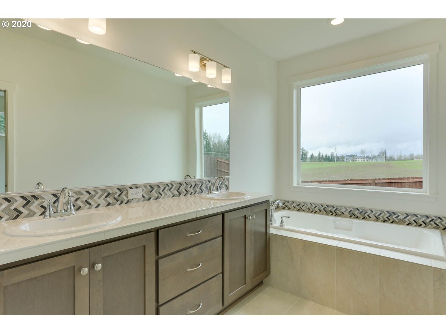 4260 South 11th Way Ridgefield, WA 98642 - Photo 14 of 18 a bathroom with a granite countertop sink mirror and a bathtub