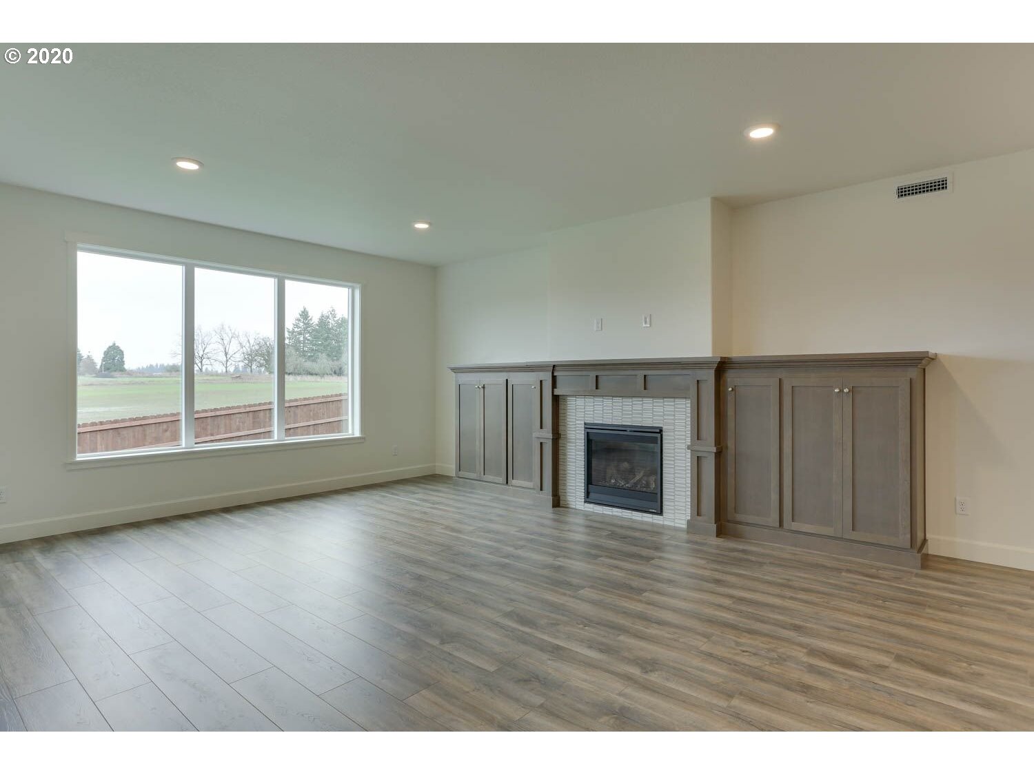 4260 South 11th Way Ridgefield, WA 98642 - Photo 10 of 18 a view of empty room with wooden floor and fireplace