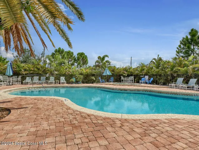 a view of a swimming pool and a yard