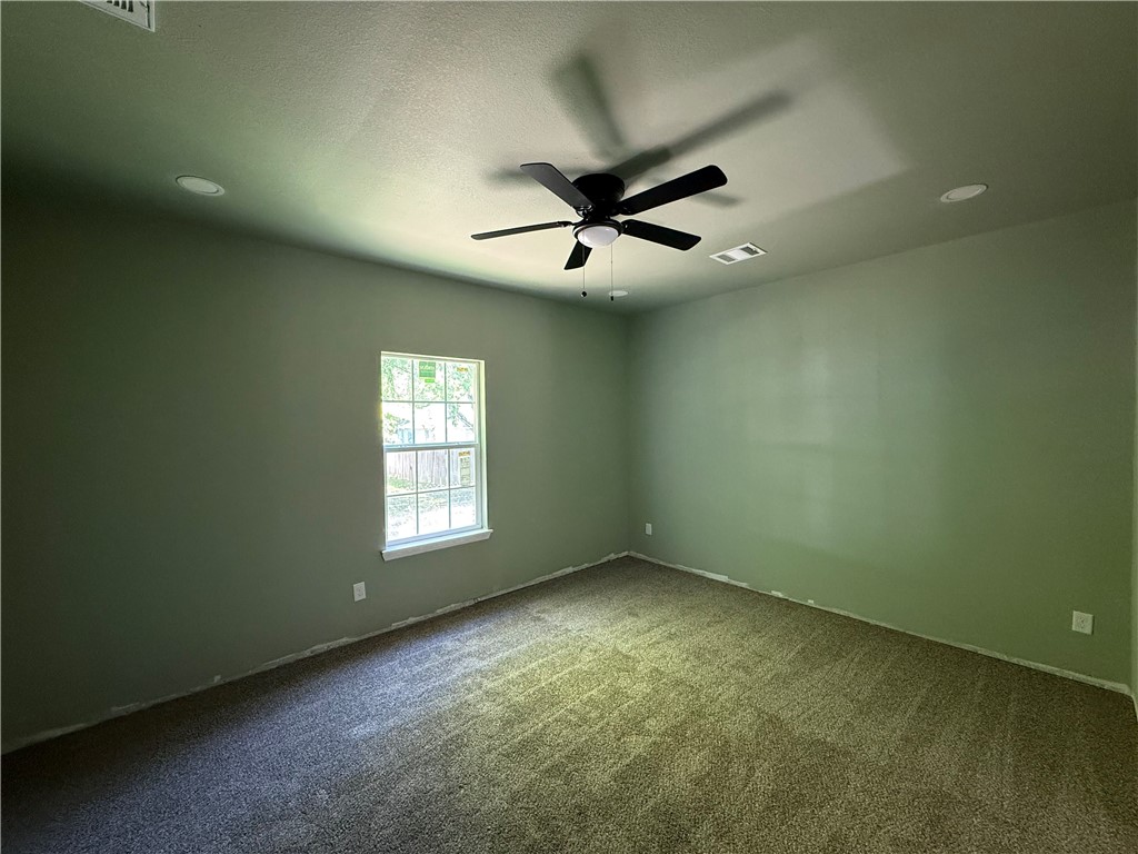 1614 Conlee Street Bryan, TX 77803 - Photo 14 of 20 an empty room with a window and a fan
