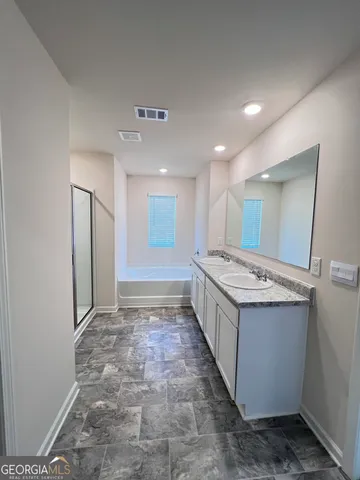 a large bathroom with a granite countertop sink and a large mirror