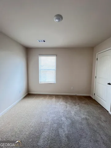 an empty room with a empty space and windows