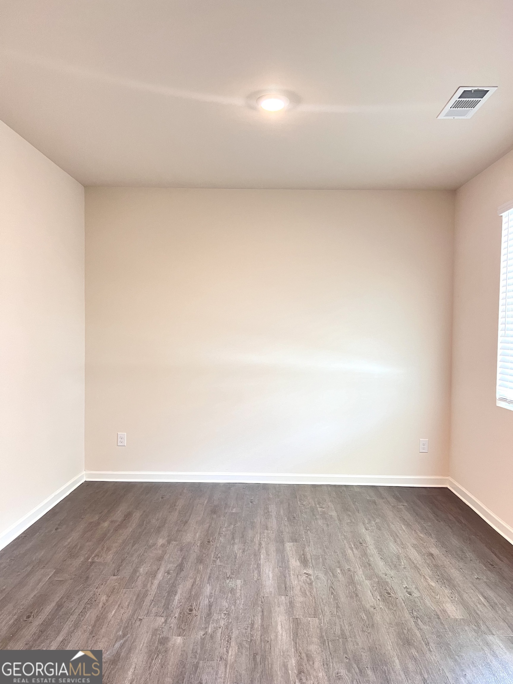 393 Walnut Grove Way Pendergrass, GA 30567 - Photo 3 of 22 a view of an empty room and wooden floor