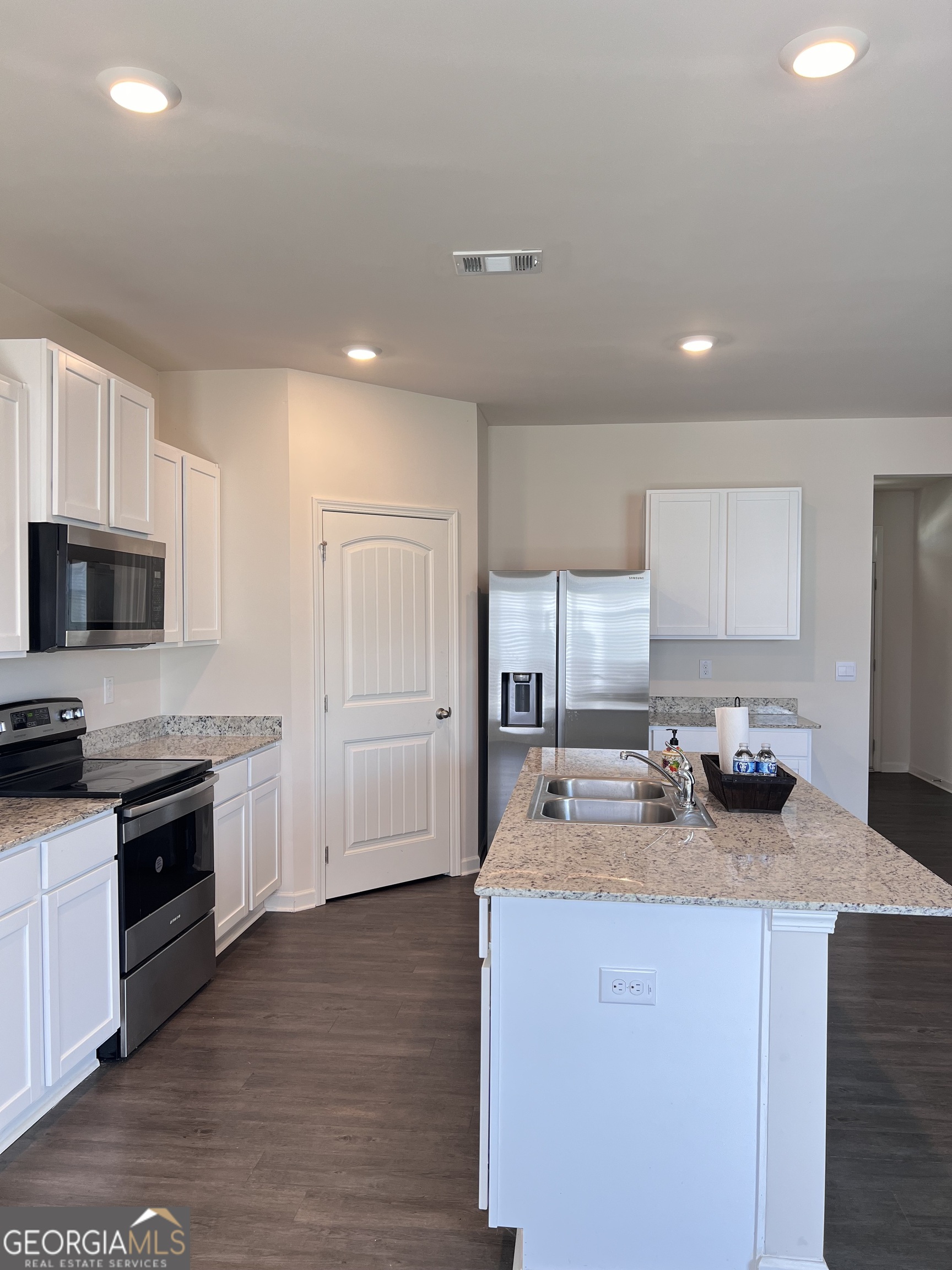 393 Walnut Grove Way Pendergrass, GA 30567 - Photo 6 of 22 a kitchen with stove a sink and refrigerator