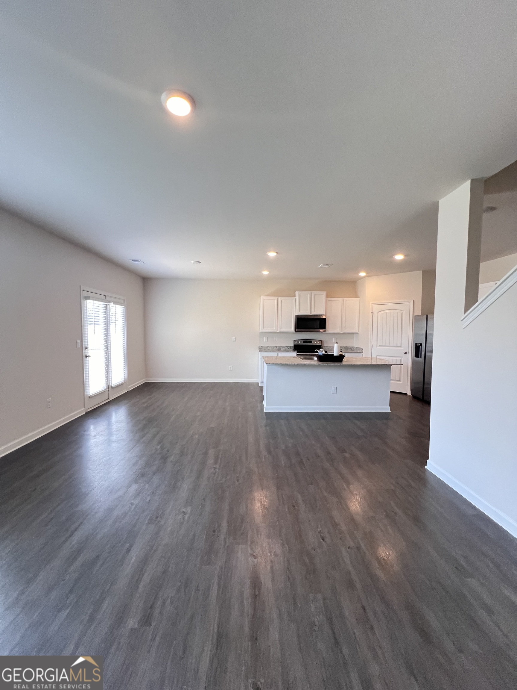 393 Walnut Grove Way Pendergrass, GA 30567 - Photo 7 of 22 a view of kitchen with stove and wooden floor