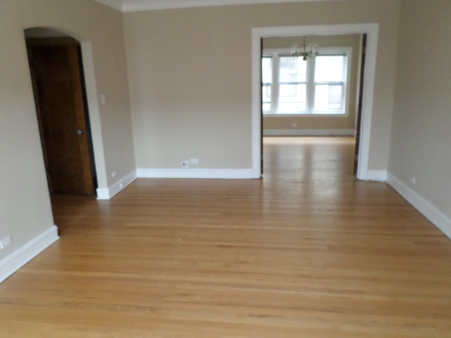 1011 Hull Terrace, Unit 22 Evanston, IL 60202 - Photo 3 of 10 a view of an empty room with wooden floor